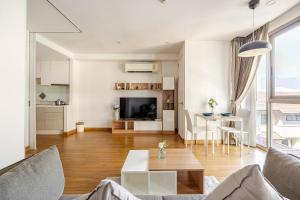 a living room with a couch and a table at The Nimmana Condo 410 - Super Deluxe 1BR Balcony extension in Chiang Mai