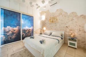 a bedroom with a large window and a bed at V&M Suite con Jacuzzi by Rentbeat in Ostuni