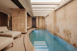 a swimming pool in the middle of a building at 1926 Les Bains Private Spa Suites in Sliema