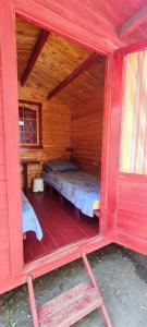 a small red room with a bed inside of it at La Cort & Căsuțe Camping Adults Only in Vama Veche