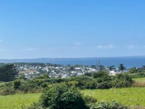 a view of a city from a hill with trees at Villa Kermilon sea view and quiet 12p in Plougasnou