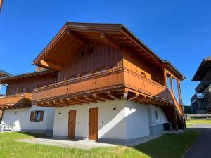 a wooden building with a balcony on top of it at Almhäuser Filzsteinalpe Almhaus 197 in Krimml