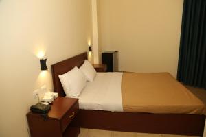 Ліжко або ліжка в номері Rumman Hotel