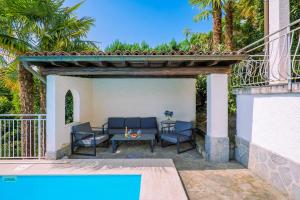 a patio with a table and chairs and a pool at Casa Cora in Agra +91 photos