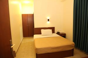 Ліжко або ліжка в номері Rumman Hotel