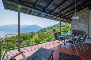 a patio with a table and chairs on a balcony at Casa Cora in Agra