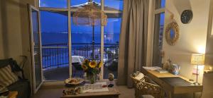 a living room with a desk and a large window at Boho Breeze Aheloy in Aheloy