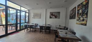 a restaurant with tables and chairs in a room with windows at Grand Bedir in Istanbul