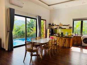 a kitchen and dining room with a table and chairs at LaLi Home in Hanoi