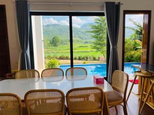 a table and chairs with a view of a pool at LaLi Home in Hanoi