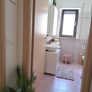 a bathroom with a sink and a toilet and a mirror at Fantasticasa in Nettuno +32 photos