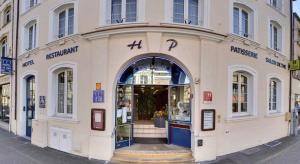 a store front of a building on a street at Logis Hotel de Paris in Saint-Avold