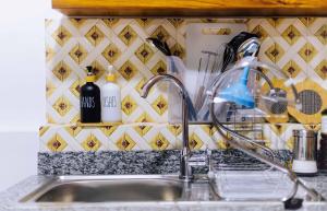 a kitchen sink with a faucet and bottles of dishes at Ngicha 1BDR APT, Dar es Salaam - Boko in Dar es Salaam +59 photos