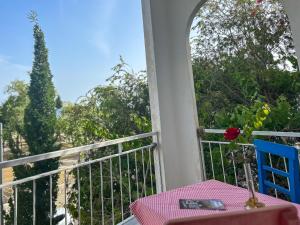 a table and a blue chair on a balcony at Anamur Nice Hotel in Anamur