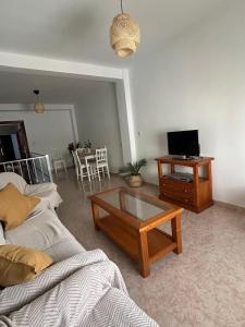 a living room with a couch and a coffee table at La buganvilla dell Torcal in Villanueva de la Concepción