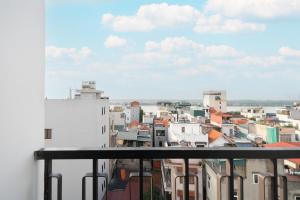 a view of a city from a balcony at The Harmony Red River Residence in Hanoi