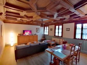 a living room with a couch and a table at Maison Kobold XVIè siècle in Wissembourg