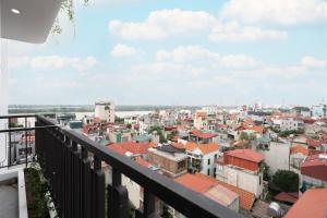 a view of a city from a balcony at The Harmony Red River Residence in Hanoi