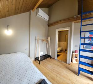 a bedroom with a bunk bed and a ladder at La Casetta Guest House 2 in Biella