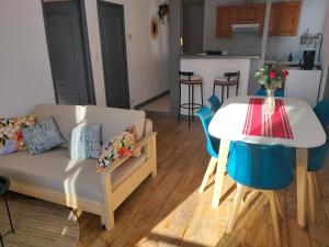 a living room with a couch and a table at Nid cosy face à la Cathedrale in Saint-Flour +11 photos