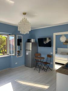 a kitchen with blue walls and a table and chairs at SUITES di LUSSO - LUXURY SUITES Maratea in Maratea