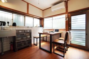 a kitchen with a table and chairs in a room at Annei-an in Ise
