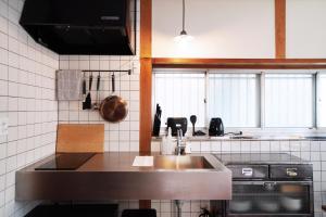 a kitchen with a sink and a stove at Annei-an in Ise