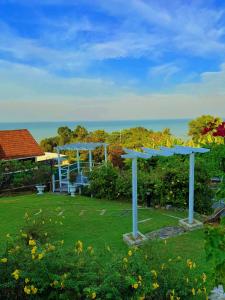 a view of a yard with two blue structures at VELAMUNDi INN Batu Ferringhi in Batu Ferringhi
