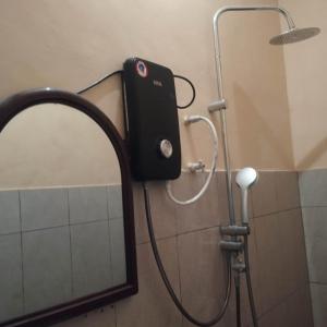 a mirror in a bathroom with a shower at sparrow family room in Nuwara Eliya