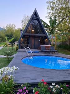 a house with a swimming pool in front of a house at Sardunya Bungalov in Sapanca