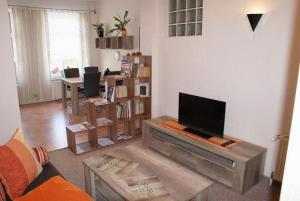 a living room with a flat screen tv on a table at Altstadtappartement - ABC59 in Wismar