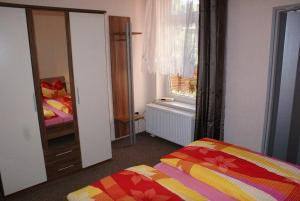 a bedroom with a bed and a window and a mirror at Altstadtappartement - ABC59 in Wismar