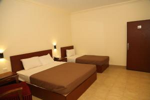 Ліжко або ліжка в номері Rumman Hotel