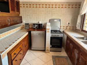 a kitchen with a stove and a sink at Rich Makuti in Watamu