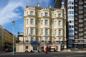 a large white building on the corner of a street at Four Points Flex by Sheraton Brighton Seafront in Brighton & Hove