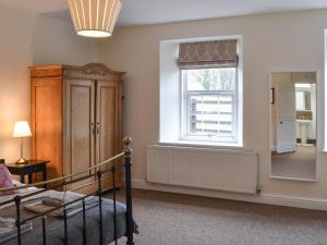 a room with a staircase and a window and a mirror at Croft Cottage in Sharperton +11 photos