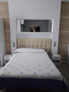 a bedroom with a bed with blue flowers on it at Hostal San Juan Oyarbide Tolosa in Tolosa
