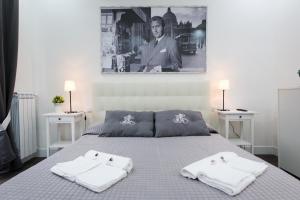 En eller flere senge i et værelse på Nido all'Aventino