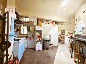 a large kitchen with white appliances and a counter at 深圳市么么熊女生青年旅店 in Shenzhen