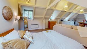 a bedroom with a large white bed in a room at The Nest in Stroud