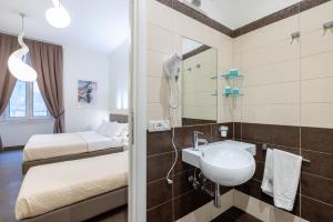 a bathroom with a sink and a mirror at Maison Trevi in Rome