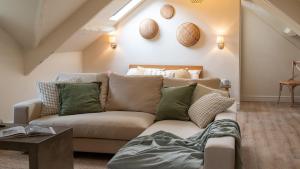 a living room with a couch in a attic at The Nest in Stroud +10 photos