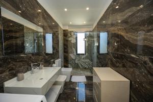 a bathroom with two sinks and a large mirror at Pomegranate House in Vlorë +38 photos