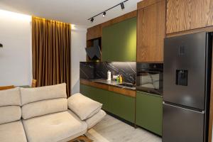 a living room with a couch and a kitchen at Pomegranate House in Vlorë