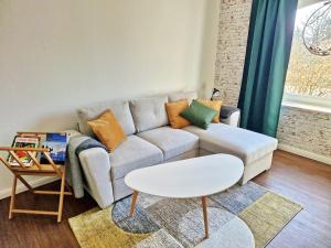 a living room with a couch and a table at FEWO-Hagemeister in Schwerin - ABC571 - keine Monteure in Schwerin +17 photos