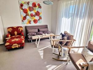 a living room with a couch and a chair at Küstenliebe in Stove Ostsee, exklusiv - ABC584 - nur Ferieng in Boiensdorf