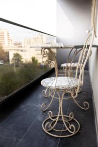 a chair sitting in front of a glass table at Q Elegance Palas Mall in Iaşi