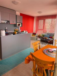 a kitchen and living room with a table and chairs at Apartment Siana in Balchik