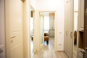 a hallway with a door leading to a bedroom at Q Elegance Palas Mall in Iaşi +25 photos