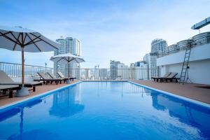 a swimming pool on the roof of a building at Galliot Hotel Nha Trang in Nha Trang